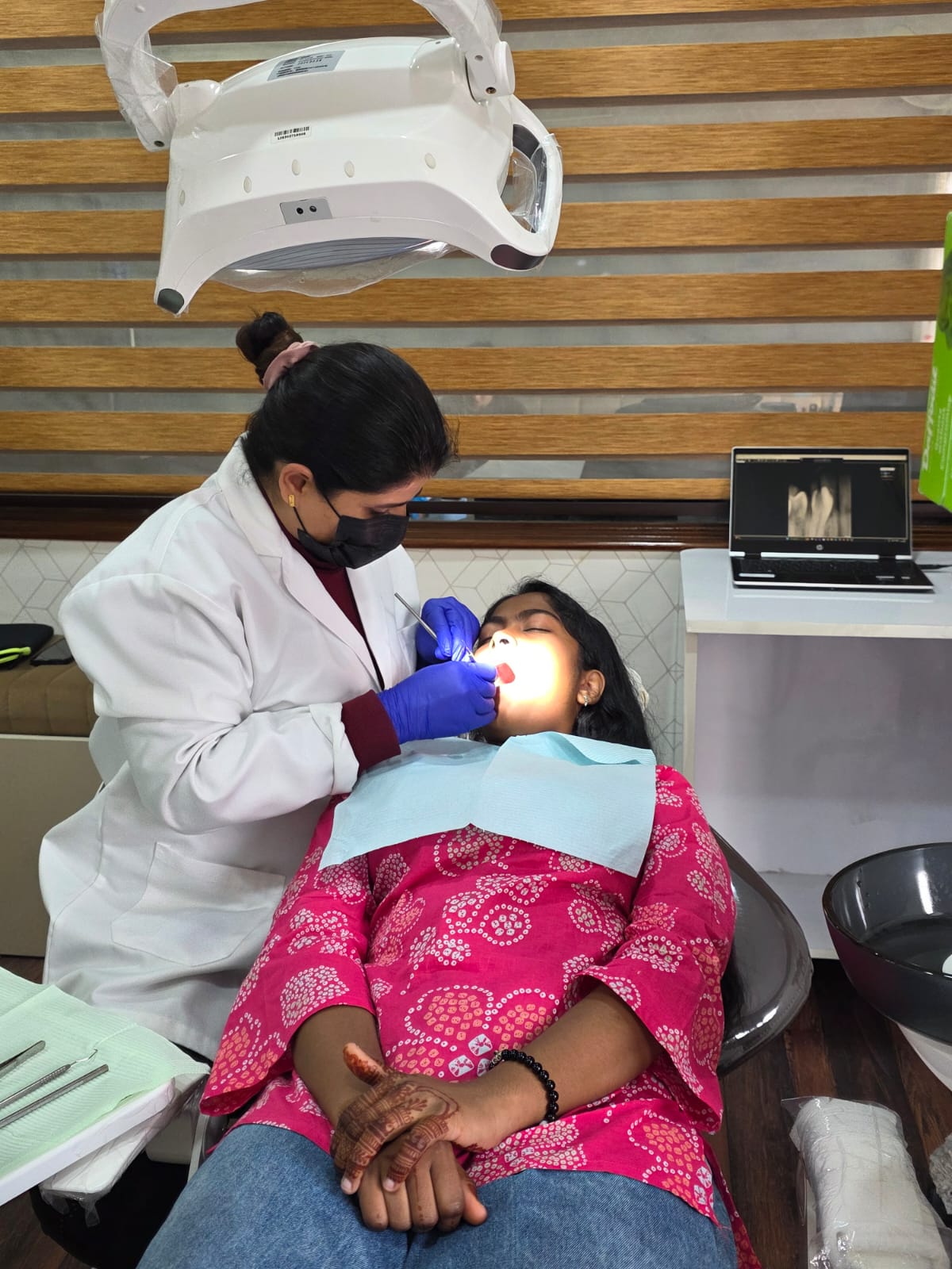 Dr. Surabhi Gupta treating a patient at Smilesure Dental Studios